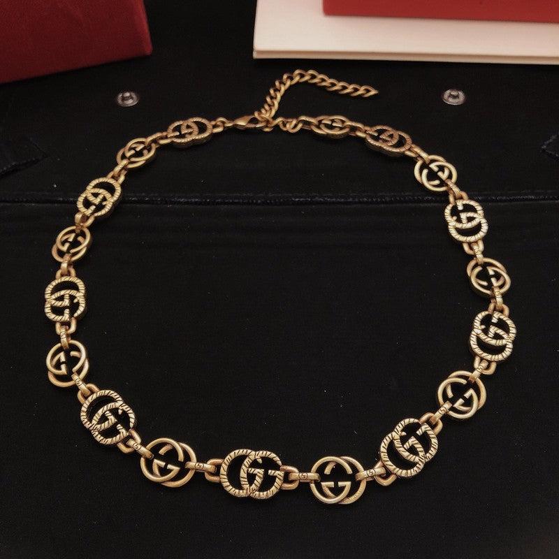 Gold chain necklace on a black surface