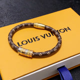 Bracelet with gold accents on a Louis Vuitton box